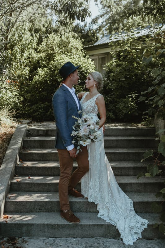 Real Weddings | Vinka Design | Real Brides Wearing Vinka Gowns | Briar and Corey on steps with bespoke dress flowing down