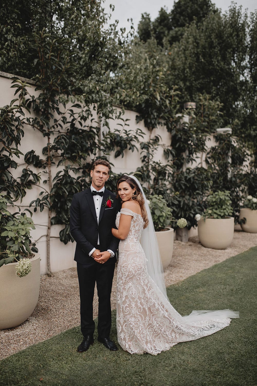 Real Weddings | Vinka Design | Real Brides Wearing Vinka Gowns | Amber and Rhys wedding ceremony black and white with off shoulder custom made wedding dress and overtrain detail