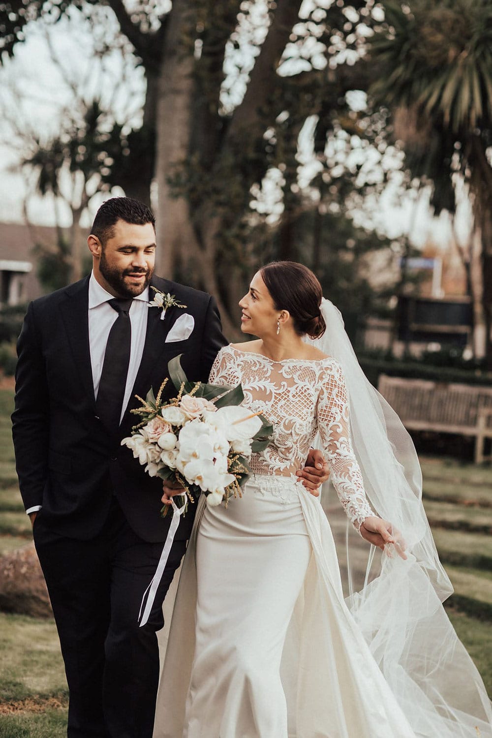 Real Weddings | Vinka Design | Real Brides Wearing Vinka Gowns | Olivia and Ben outdoors posing together with flower bouquet