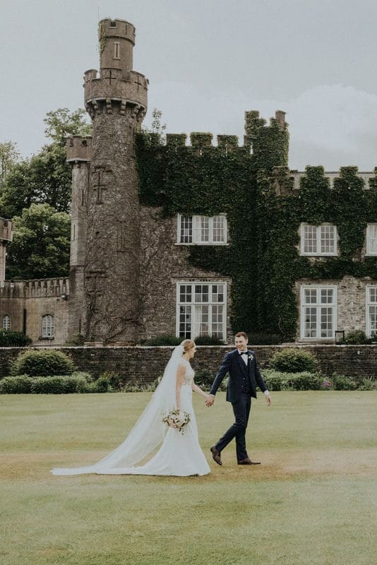 Real Weddings | Vinka Design | Real Brides Wearing Vinka Gowns | Paige and Ciaran - walk along outside castle