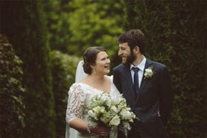 Testimonials | Vinka Design | Real Bridal Reviews from Our Clients | Lydia and Ben outdoors with beautiful mid length lace sleeves