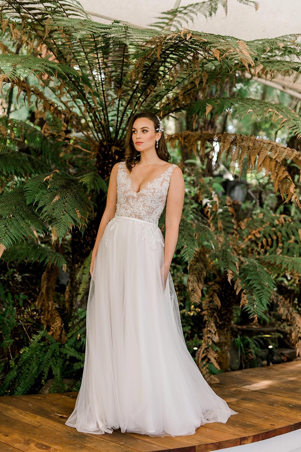 Vivian Wedding gown from Vinka Design Curve Collection - A stunning gown with a deep V-neckline on both the front & back. Fitted semi-sheer nude bodice embellished with a beaded floral lace, a soft layered tulle skirt.