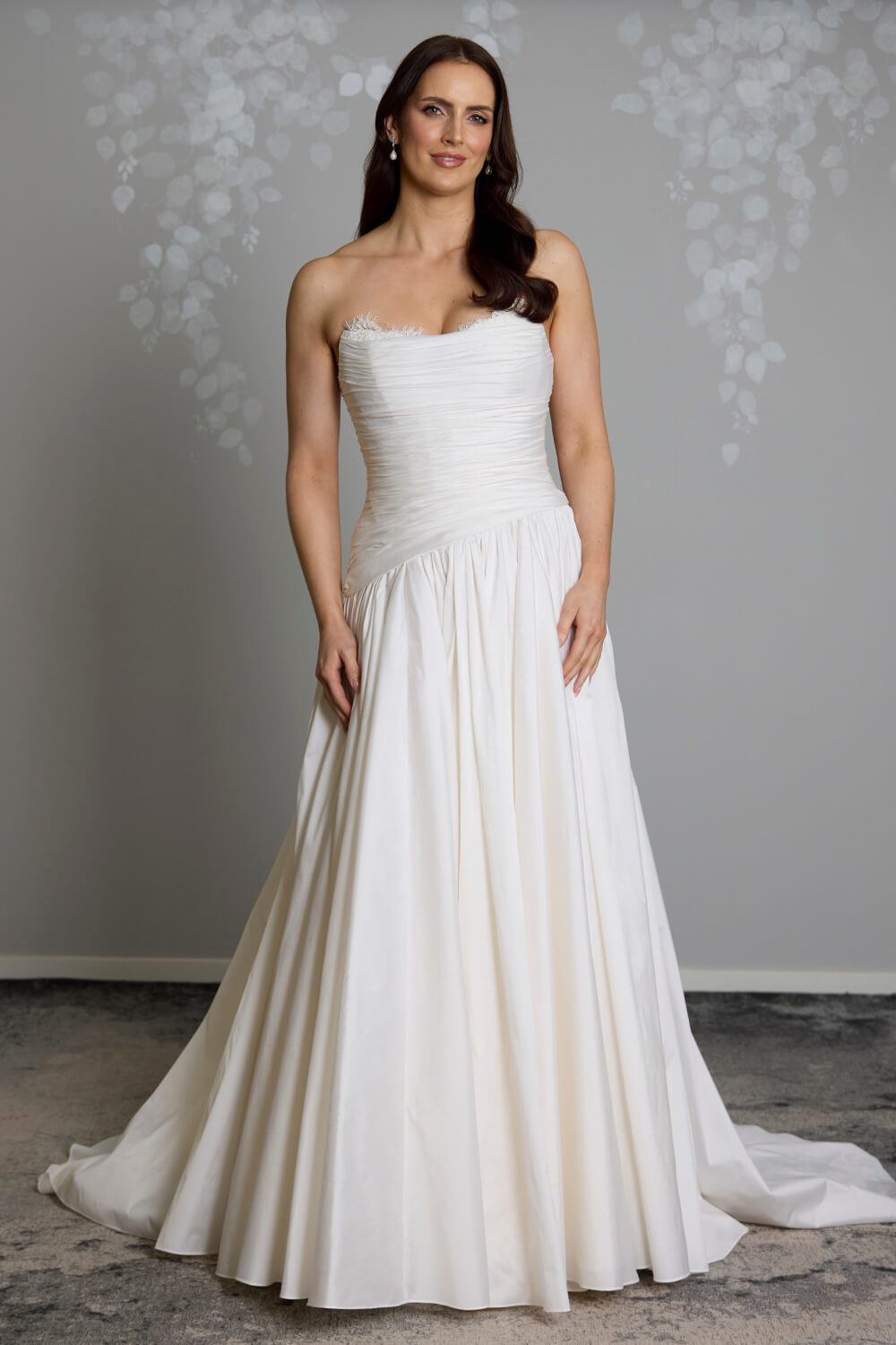 Amelia silk-touch taffeta wedding gown with dropped waist, draped bodice, lace neckline and full gathered skirt