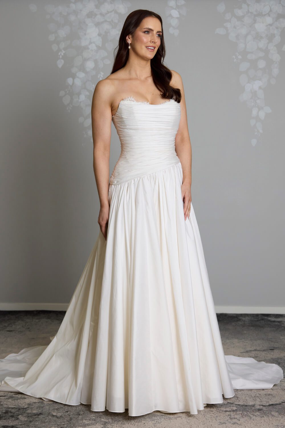 Amelia silk-touch taffeta wedding gown with dropped waist, draped bodice, lace neckline and full gathered skirt