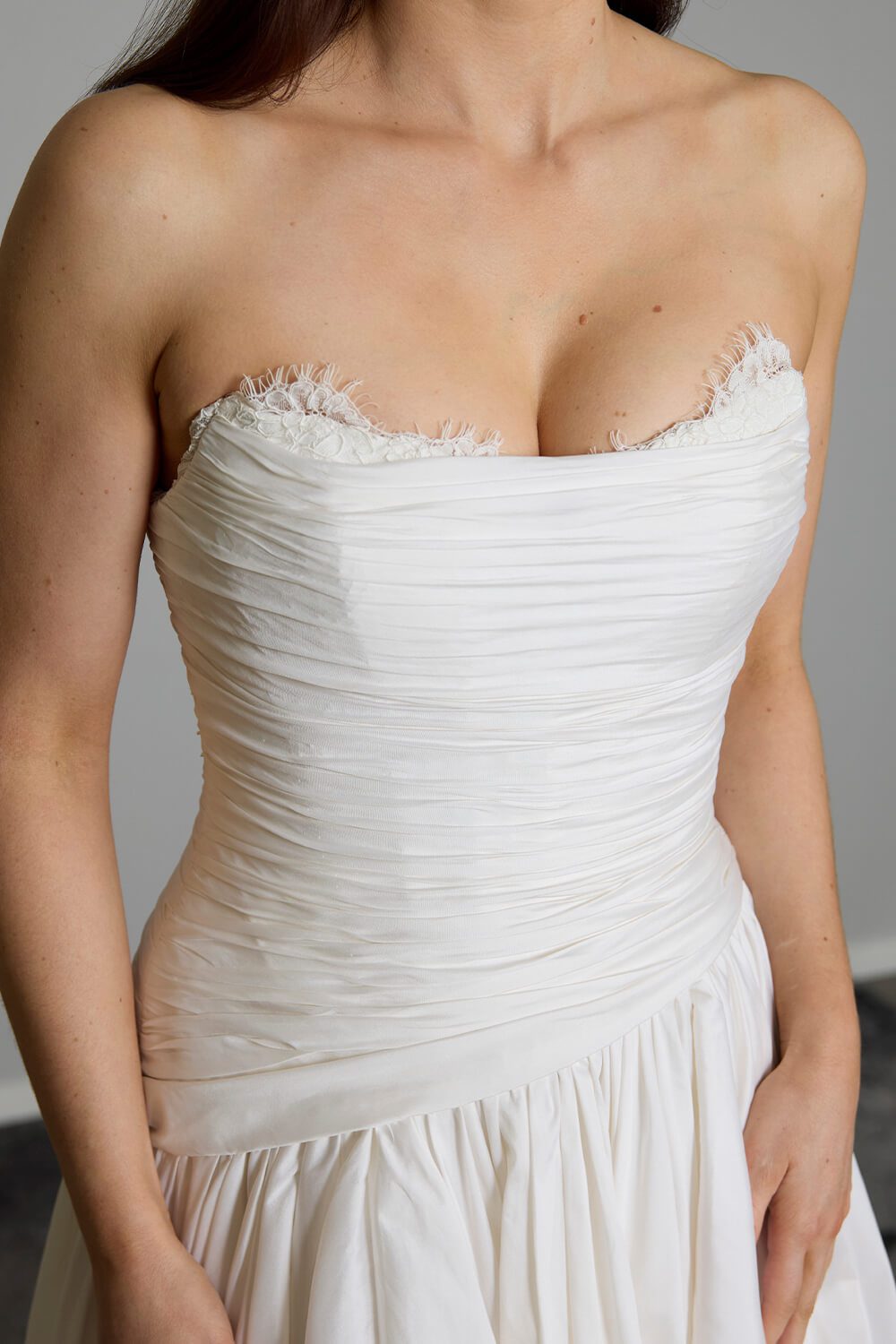 Amelia silk-touch taffeta wedding gown with dropped waist, draped bodice, lace neckline and full gathered skirt