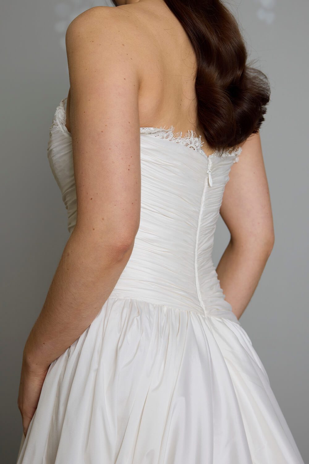 Amelia silk-touch taffeta wedding gown with dropped waist, draped bodice, lace neckline and full gathered skirt