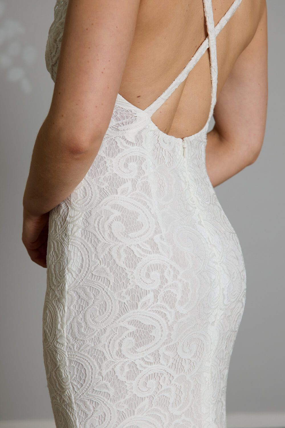 Cove stretch lace wedding dress with cowl neckline, low cross-strap back and light nude power stretch base