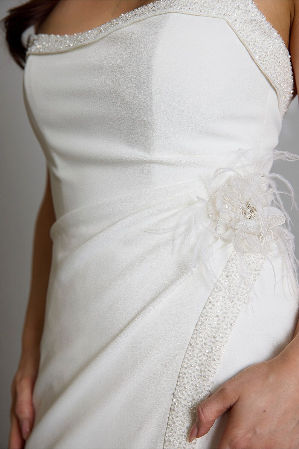 Hallie bridal crepe wedding gown with scoop neckline, seed pearl and bugle bead embellishment, crossover skirt and side split