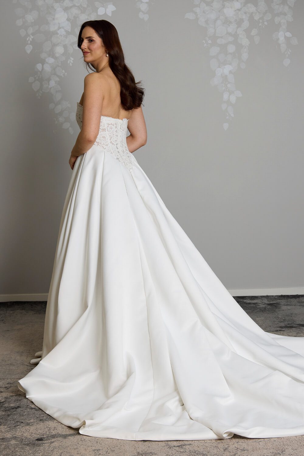 Indie strapless lace wedding dress with semi-sheer boned bodice, inverted pleated Duchesse satin skirt and button detailing down the back