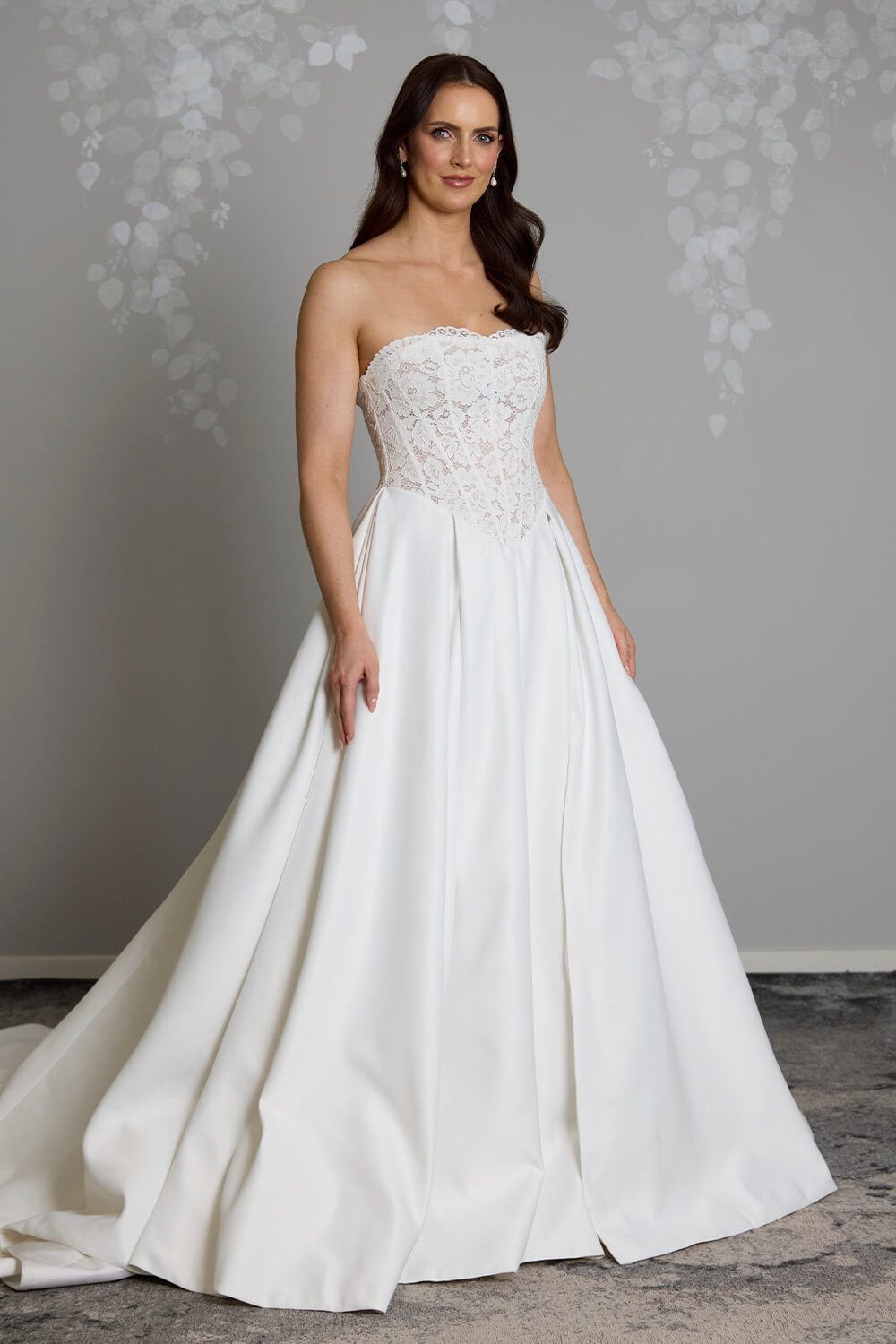 Indie strapless lace wedding dress with semi-sheer boned bodice, inverted pleated Duchesse satin skirt and button detailing down the back
