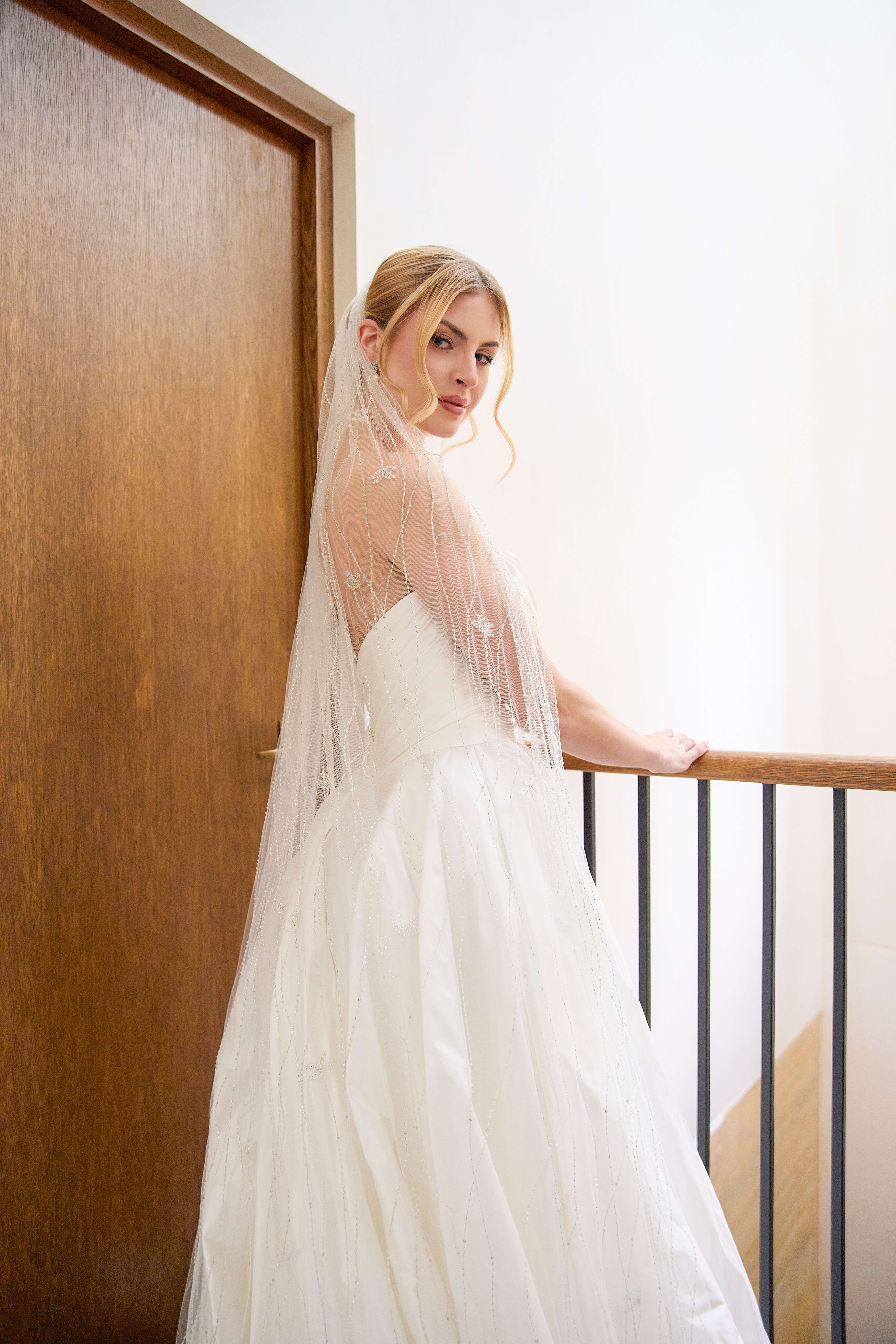 Isabelle silk wedding gown featuring a strapless bodice with sculptural draping, a softly ruched silhouette and a sweeping train.