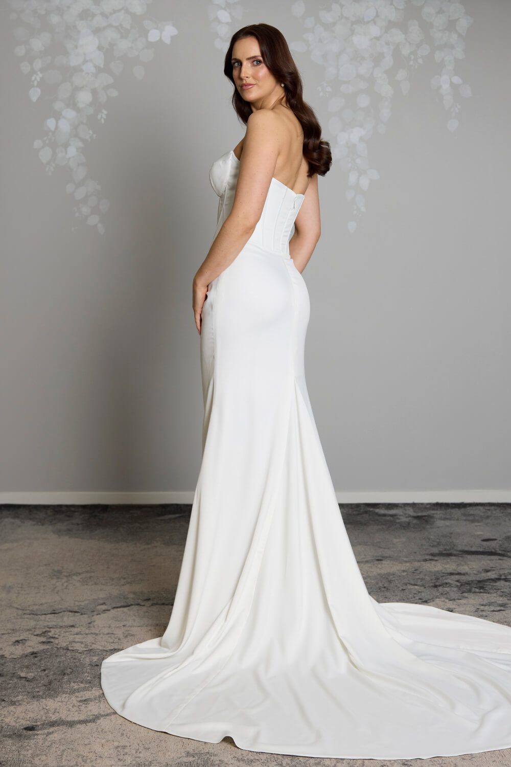 Noa Toscano soft satin corset wedding gown with exposed boning, draped slim skirt and crystal embellished off-shoulder detail