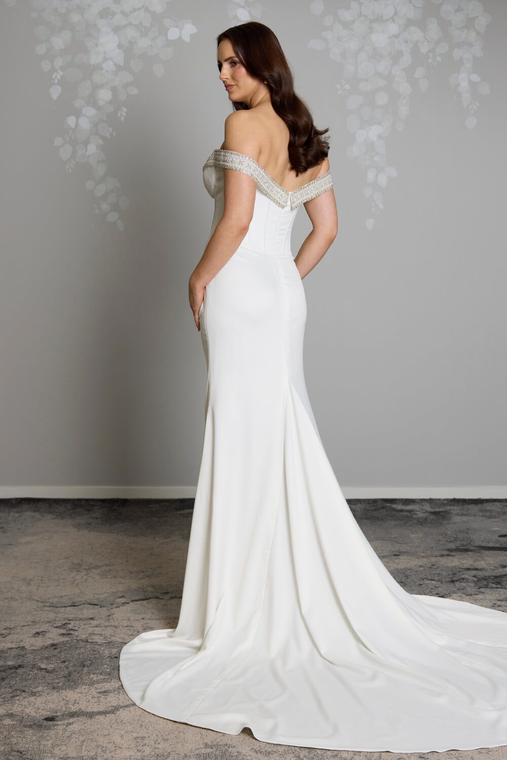 Noa Toscano soft satin corset wedding gown with exposed boning, draped slim skirt and crystal embellished off-shoulder detail