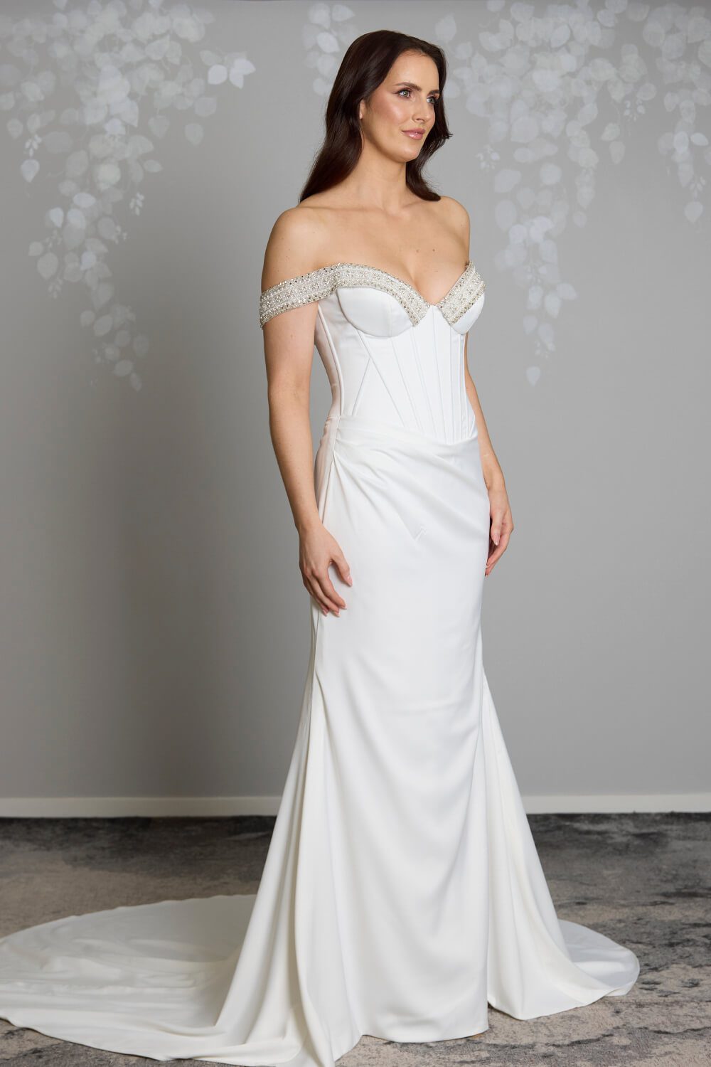 Noa Toscano soft satin corset wedding gown with exposed boning, draped slim skirt and crystal embellished off-shoulder detail