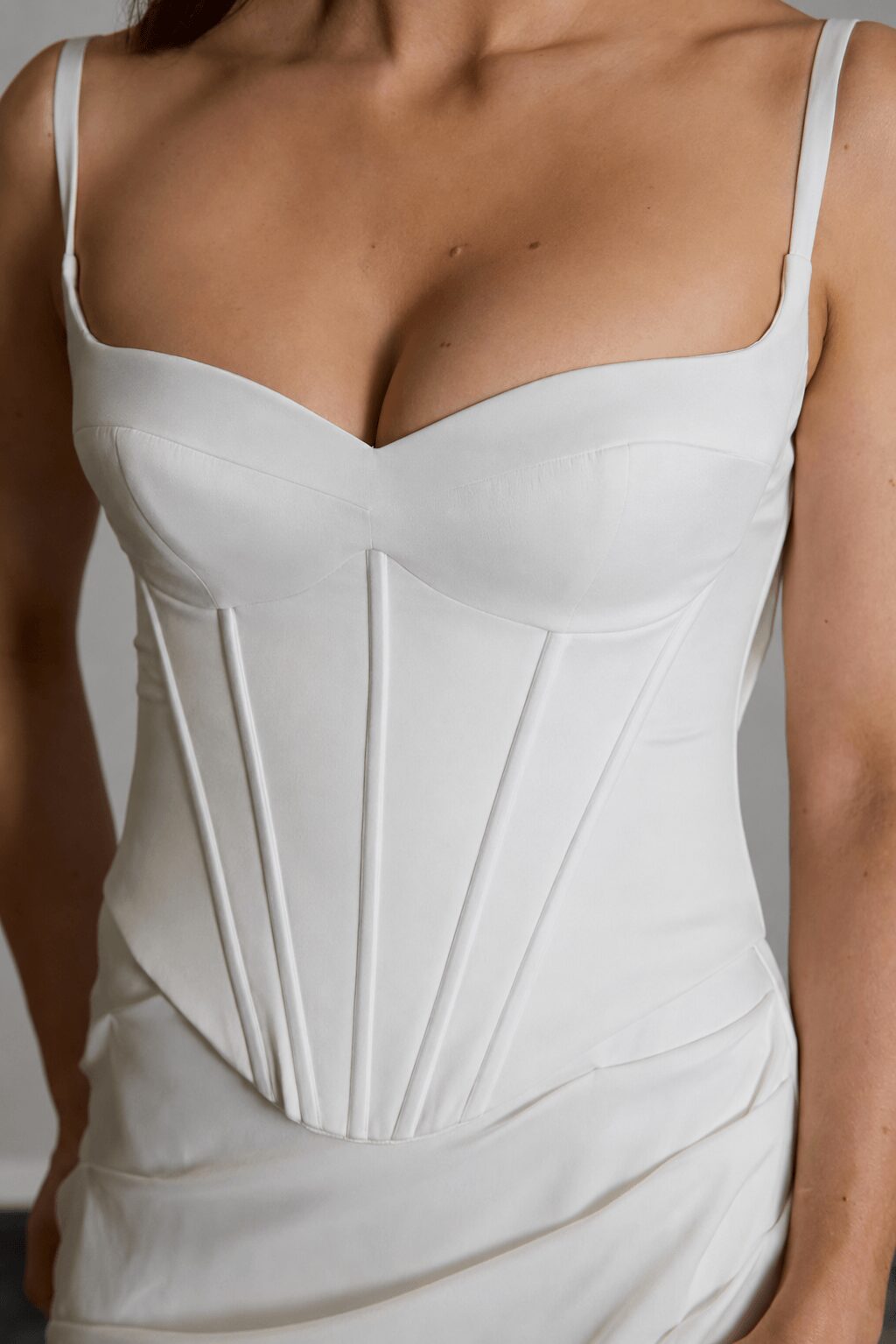 Odette two-piece satin wedding dress with structured corset bodice, lace back detailing, fit-and-flare skirt and lace train insert