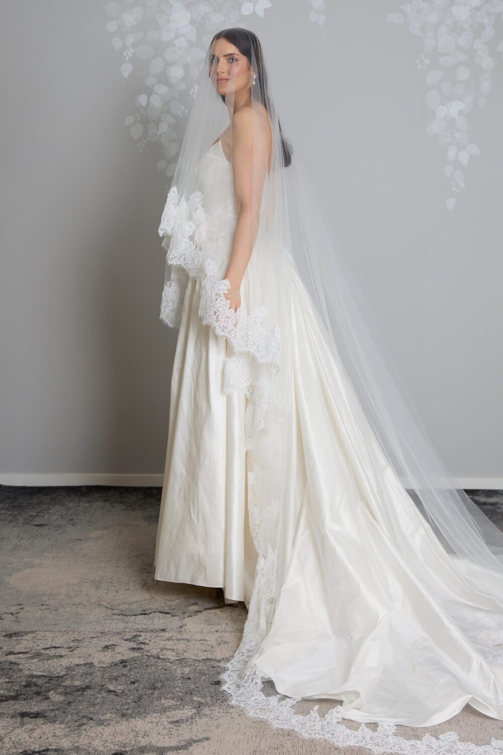 Grace two-tier bridal veil by Vinka Design, crafted from light ivory tulle with a corded Chantilly lace edge and 80 cm blusher, styled with an ivory wedding gown.