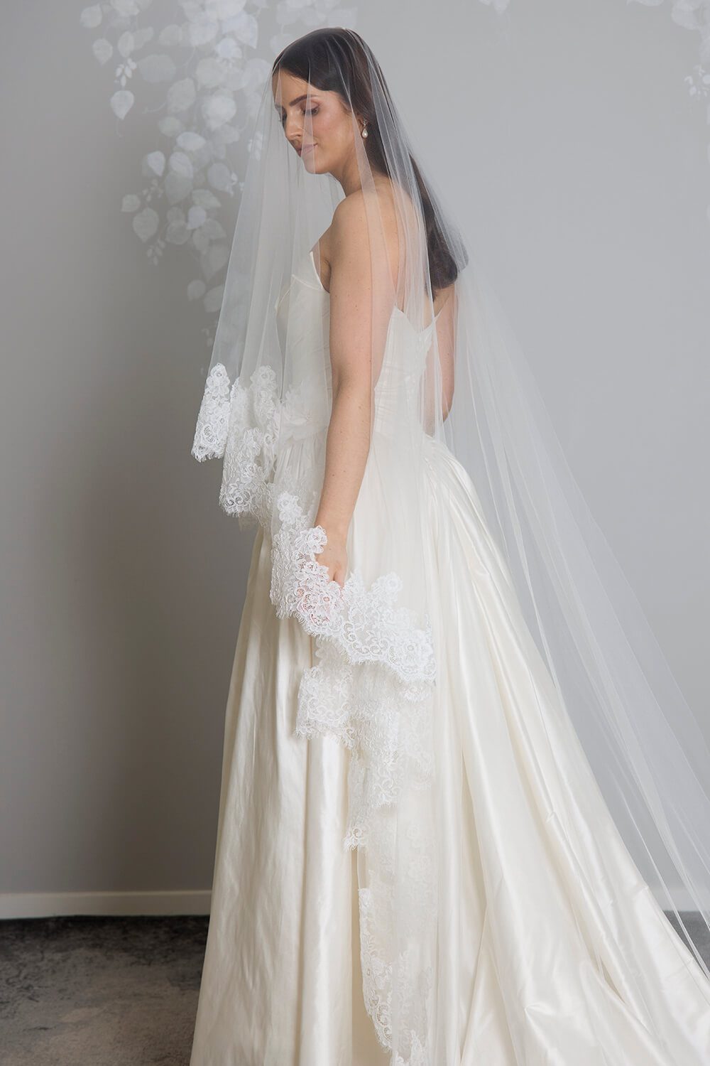 Grace two-tier bridal veil by Vinka Design, crafted from light ivory tulle with a corded Chantilly lace edge and 80 cm blusher, styled with an ivory wedding gown.