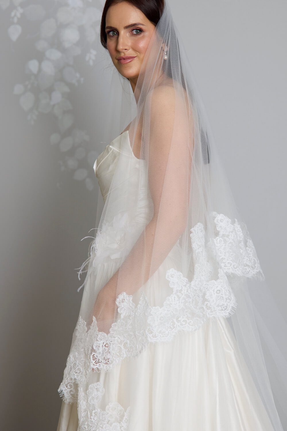 Grace two-tier bridal veil by Vinka Design, crafted from light ivory tulle with a corded Chantilly lace edge and 80 cm blusher, styled with an ivory wedding gown.