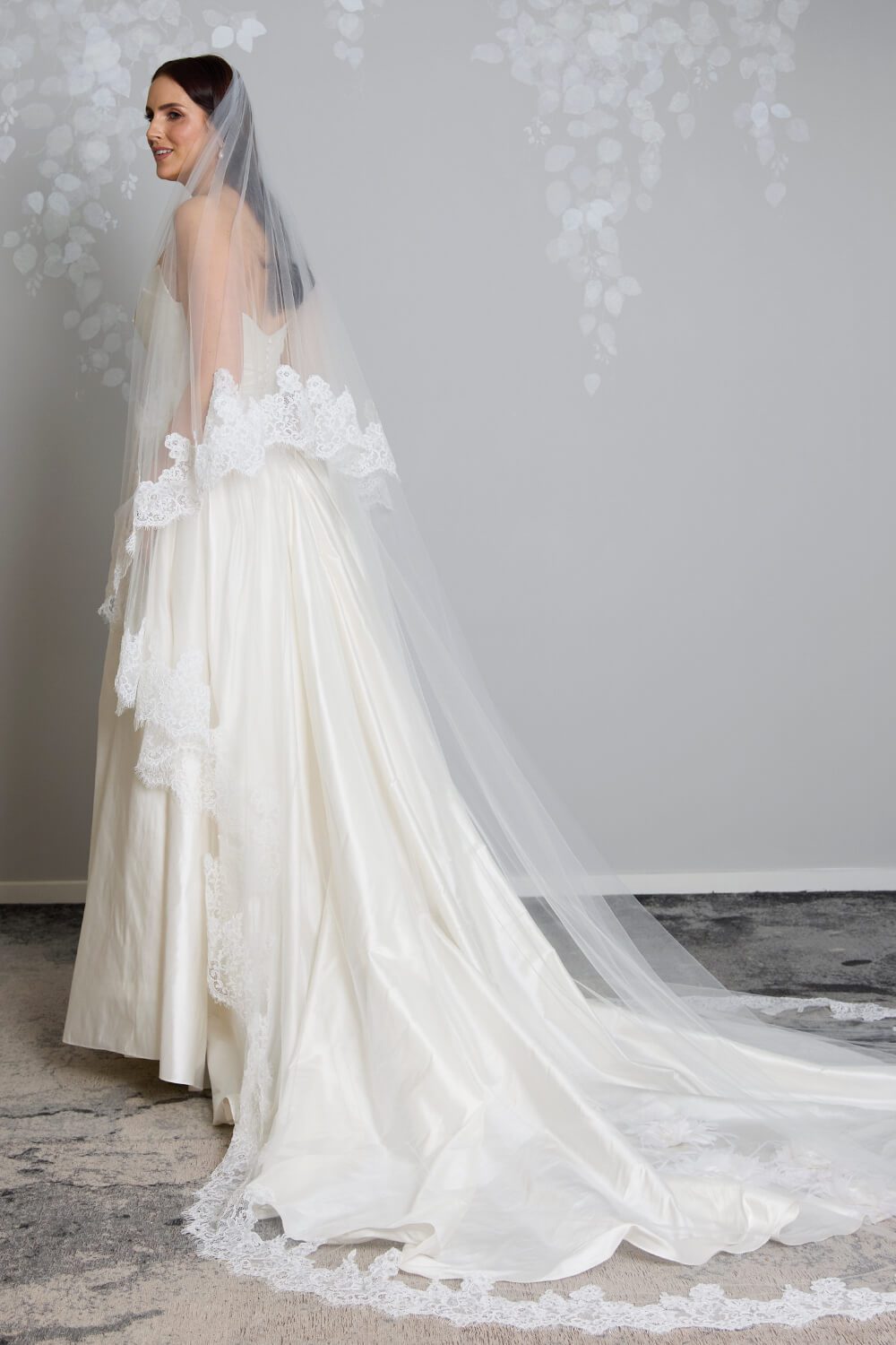 Grace two-tier bridal veil by Vinka Design, crafted from light ivory tulle with a corded Chantilly lace edge and 80 cm blusher, styled with an ivory wedding gown.