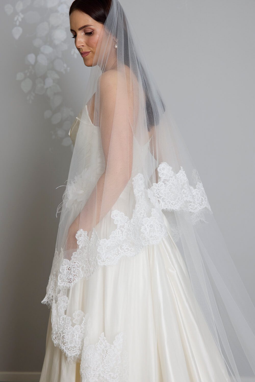 Grace two-tier bridal veil by Vinka Design, crafted from light ivory tulle with a corded Chantilly lace edge and 80 cm blusher, styled with an ivory wedding gown.