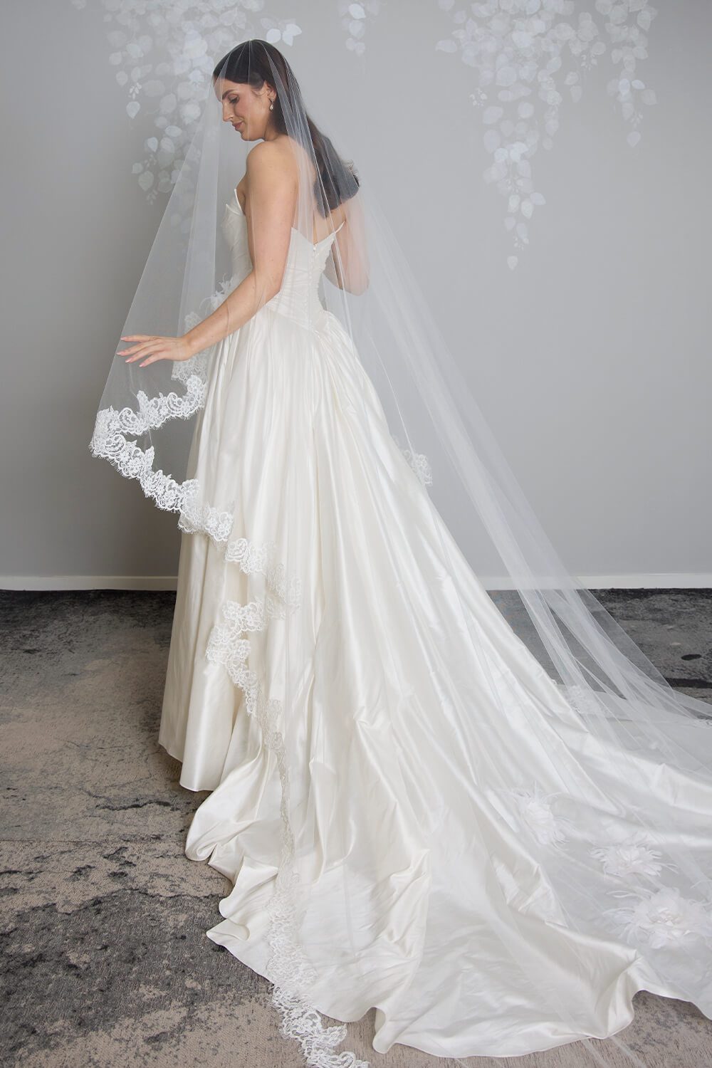 Margarita corded Chantilly lace mantilla veil with intricate lace edging framing the bride’s face and falling over her wedding gown.