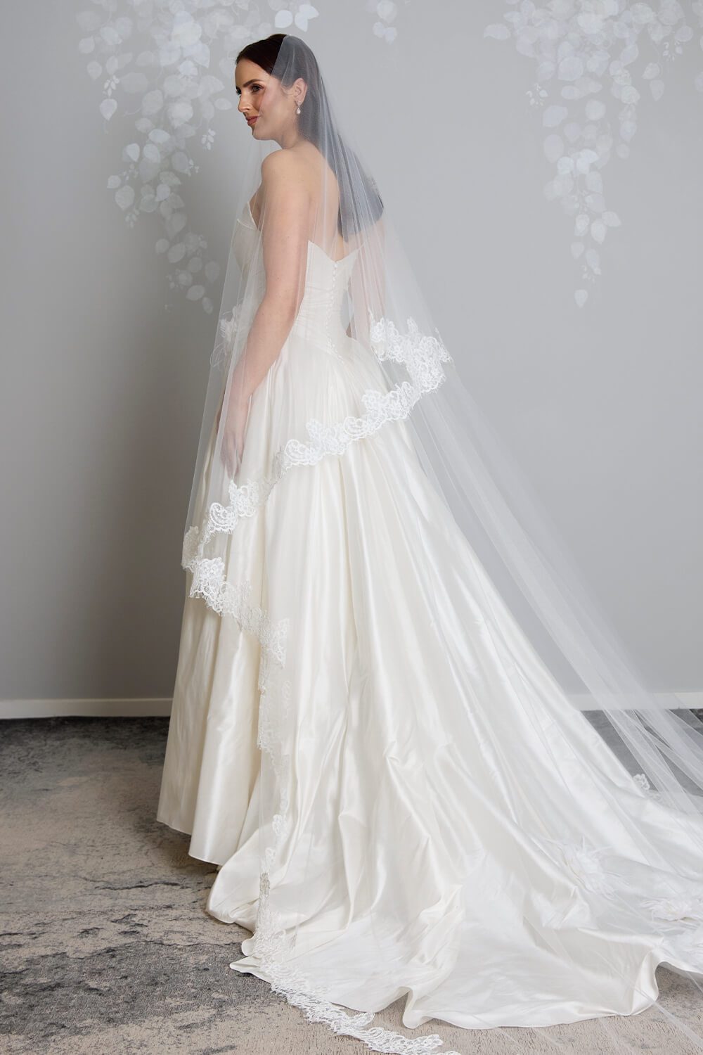 Margarita corded Chantilly lace mantilla veil with intricate lace edging framing the bride’s face and falling over her wedding gown.