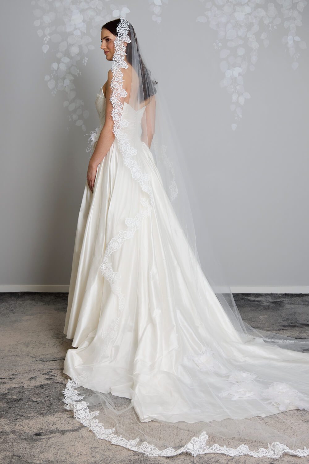 Margarita corded Chantilly lace mantilla veil with intricate lace edging framing the bride’s face and falling over her wedding gown.