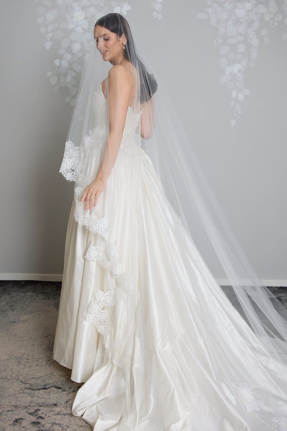 Margarita corded Chantilly lace mantilla veil with intricate lace edging framing the bride’s face and falling over her wedding gown.